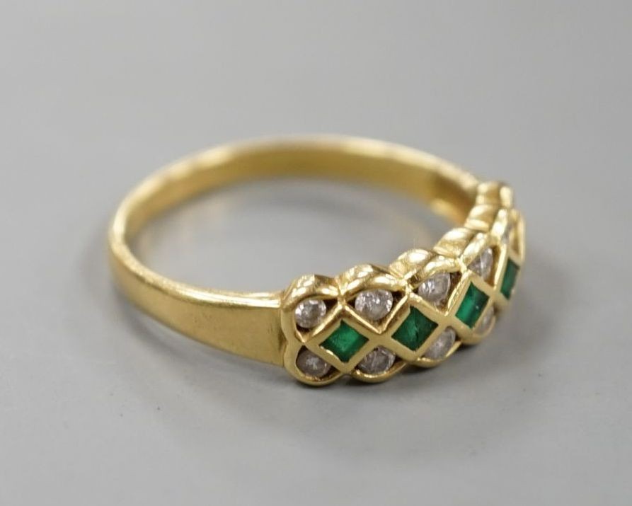 A modern 18ct gold, emerald and diamond line cluster set half hoop ring, size R, gross 3.9 grams.